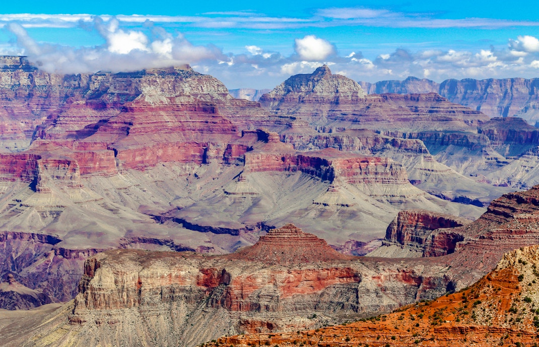 Grand Canyon's layered rock formations under a clear blue sky.