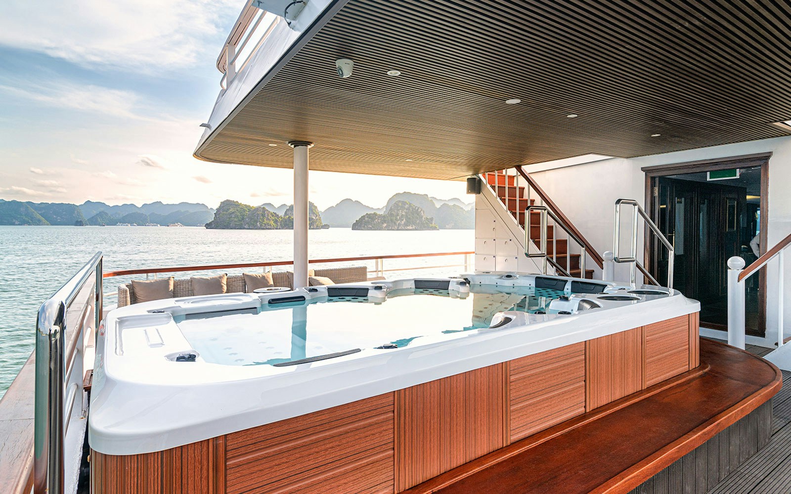 Ha Long Bay 5-Star Cruise ship sailing past limestone karsts and emerald waters in Vietnam.