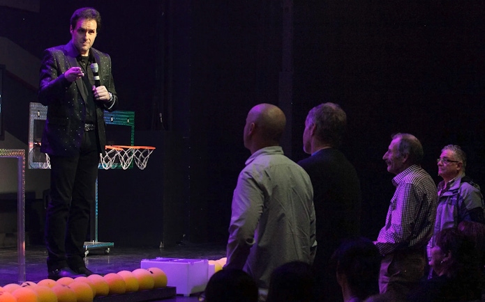 Performer engaging audience during The Mentalist show.