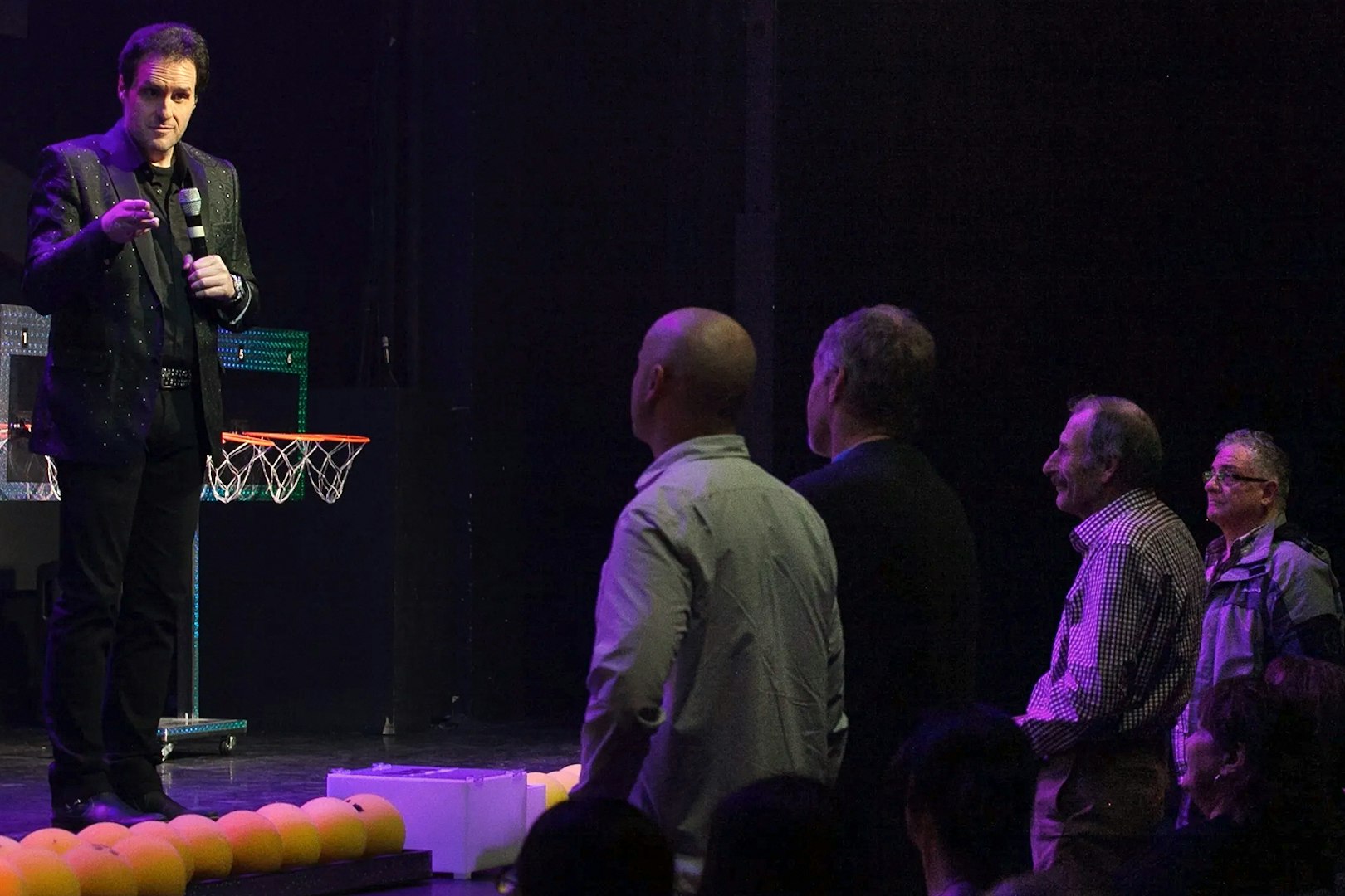 Performer engaging audience during The Mentalist show.