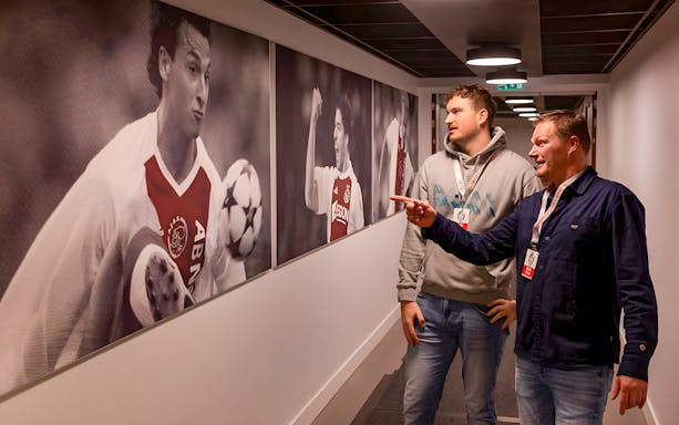Visitors admire football memorabilia at Johan Cruijff ArenA Classic Tour.