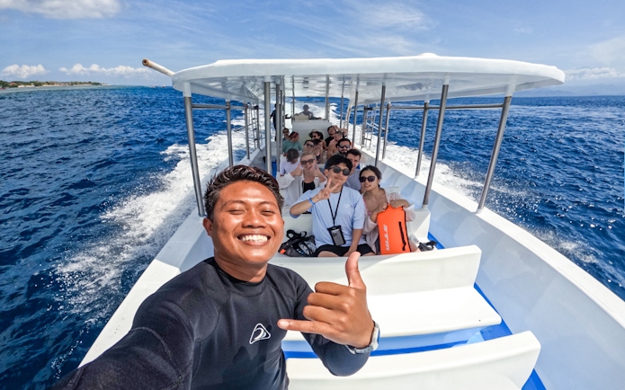 Tourists on a boat heading to Nusa Lembongan for a snorkeling day tour at Manta Bay.