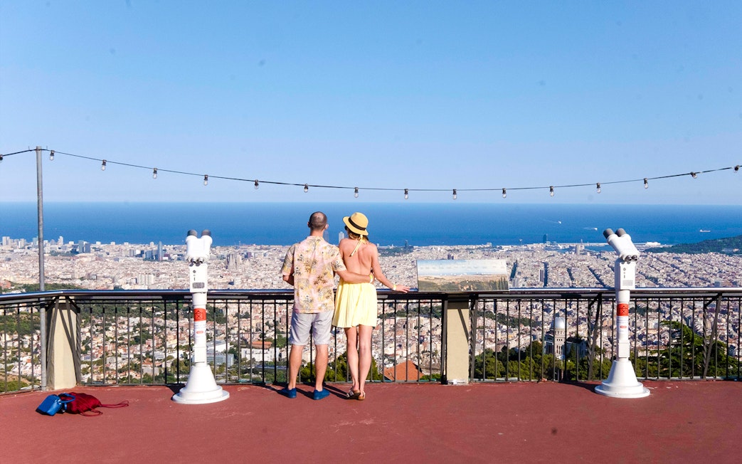 Visitors enjoying the view of Barcelona from Tibidabo Amusement Park.