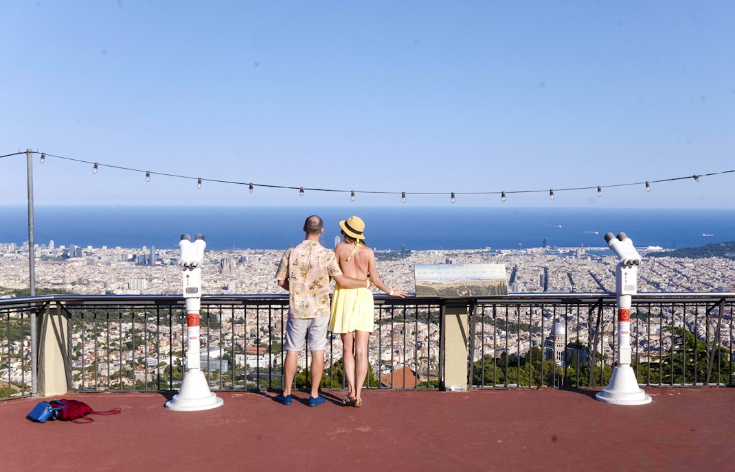 Visitors enjoying the view of Barcelona from Tibidabo Amusement Park.