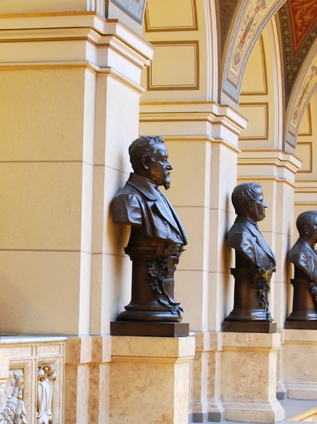 Busts lining the ornate hallway of the National Prague Museum interior.