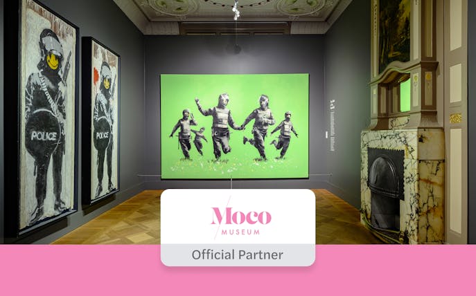 Moco Museum Amsterdam Banksy exhibit featuring police-themed artwork.