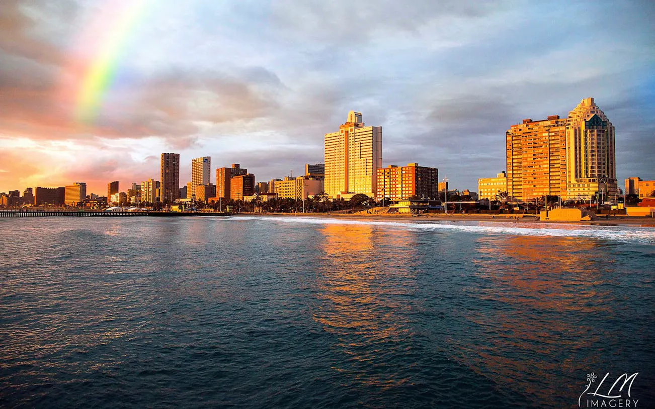 Durban city skyline with a rainbow over the ocean during a half-day sightseeing tour.