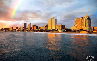 Durban city skyline with a rainbow over the ocean during a half-day sightseeing tour.