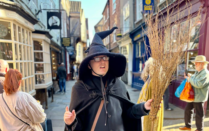 Tour guide in witch costume on York Old Town walking tour.