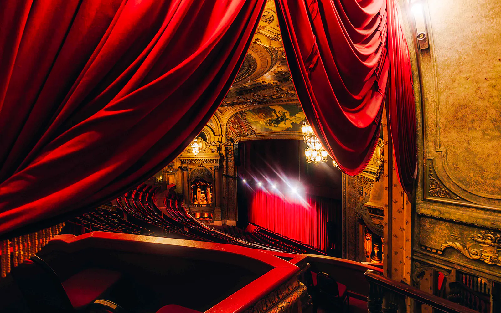 Interior view of The Chicago Theatre with ornate architecture and red curtains.