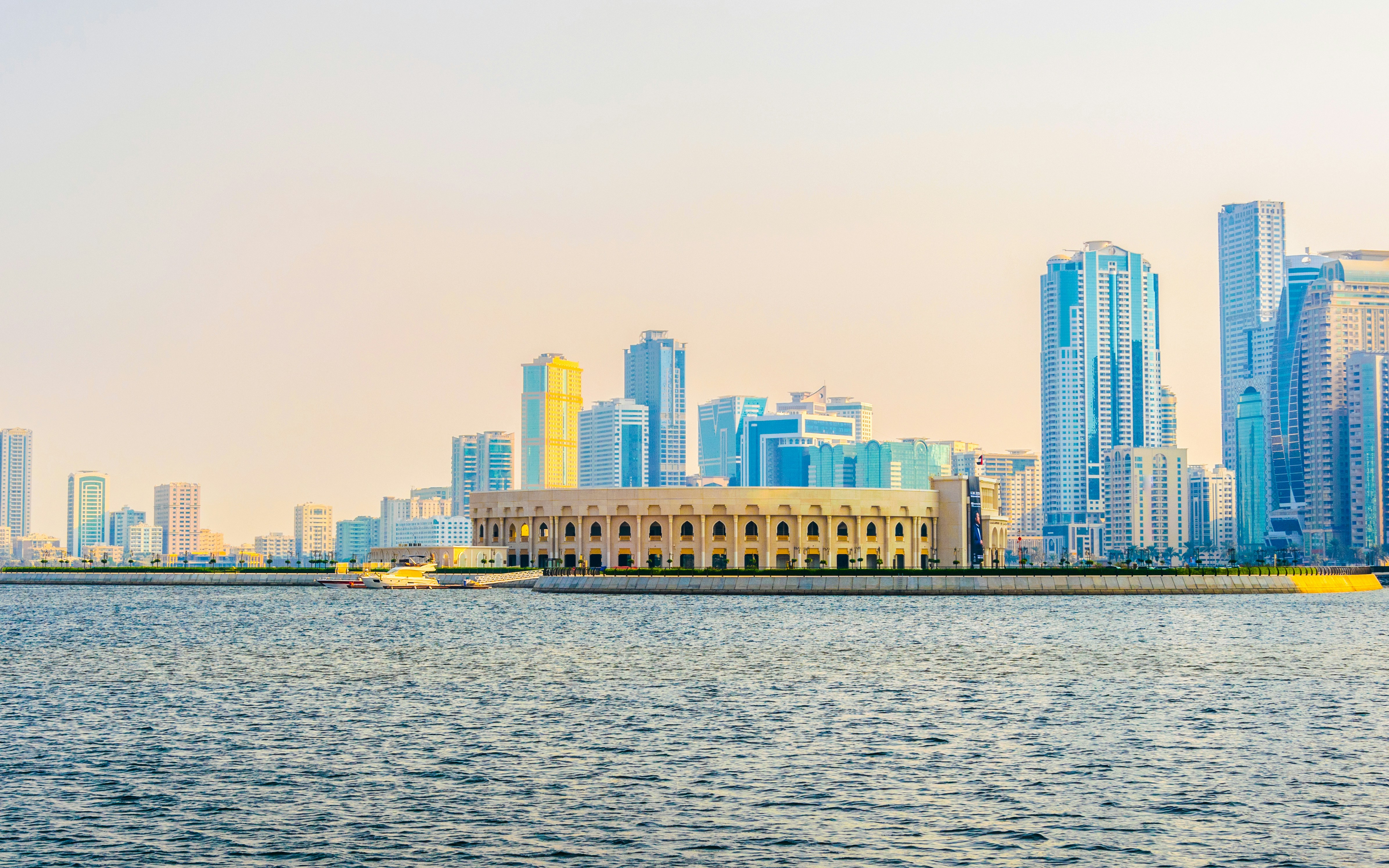 Khalid Lagoon view with Al Majaz Amphitheatre and Sharjah skyline in the background.