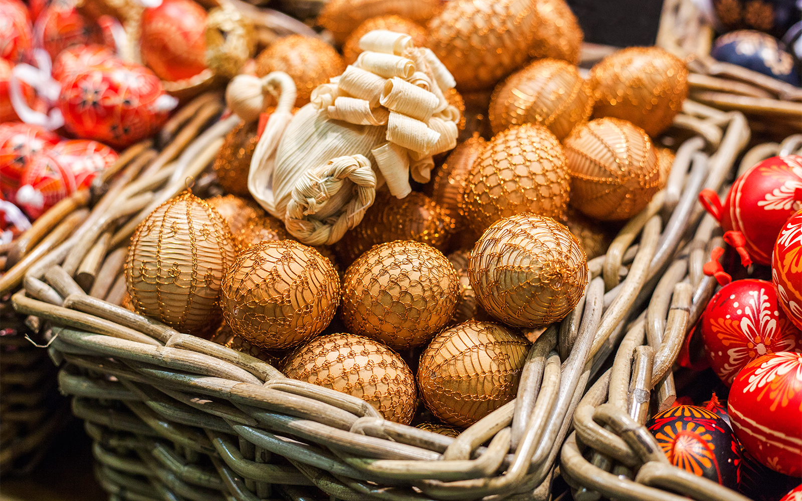 Easter eggs in toy form in a basket with a festive background.