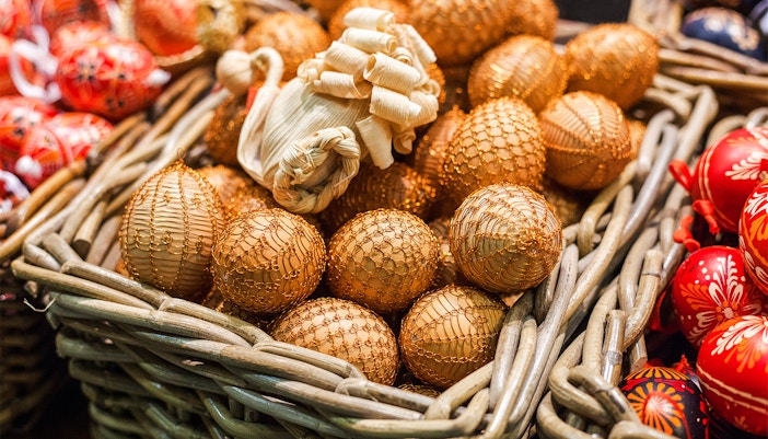 Easter eggs in toy form in a basket with a festive background.
