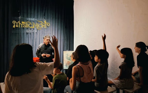 Audience watching performer at The Mystic Night Show, inspired by Vietnamese folktale.