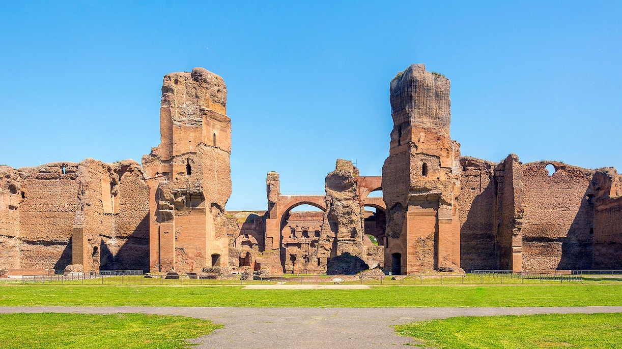 Ancient ruins of the Baths of Caracalla in Rome, showcasing towering brick structures.