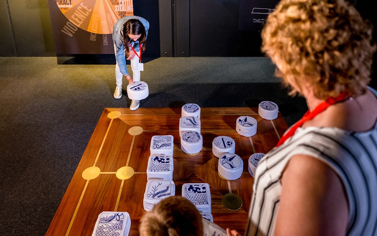 Interactive exhibit at Port Arthur Historic Site gallery, featuring visitors engaging with historical artifacts.