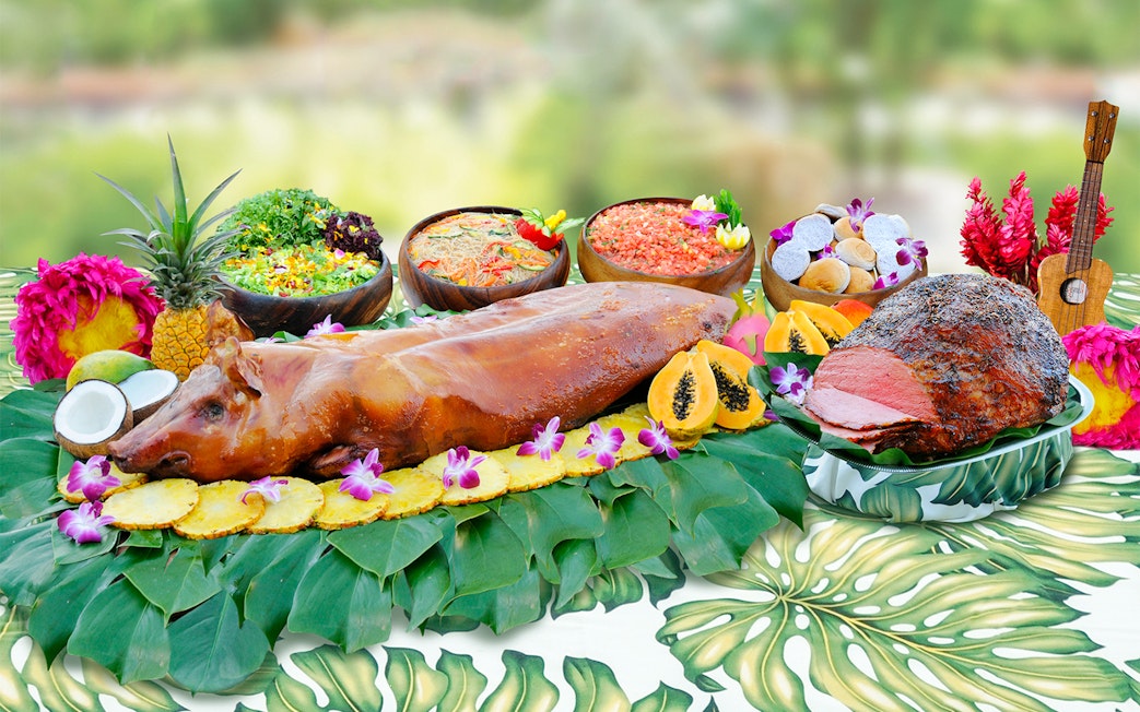 Waikiki Luau buffet with roast pig, tropical fruits, and salads at Rock-A-Hula Show.