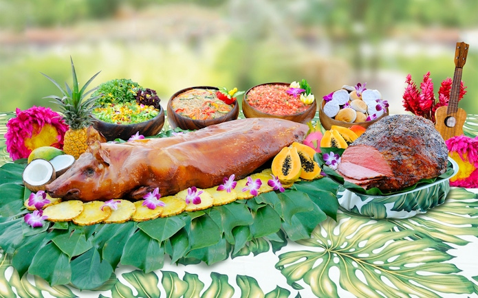 Waikiki Luau buffet with roast pig, tropical fruits, and salads at Rock-A-Hula Show.