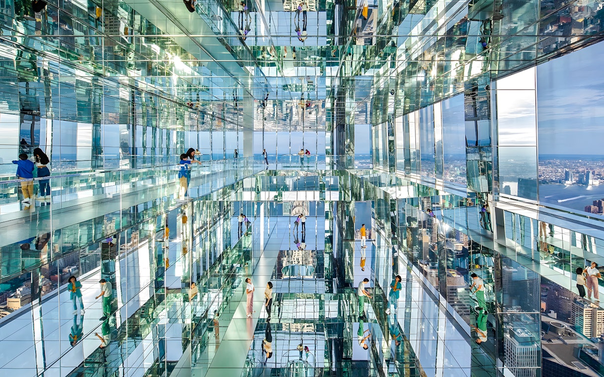 Visitors exploring mirrored observation deck at SUMMIT One Vanderbilt, New York City.