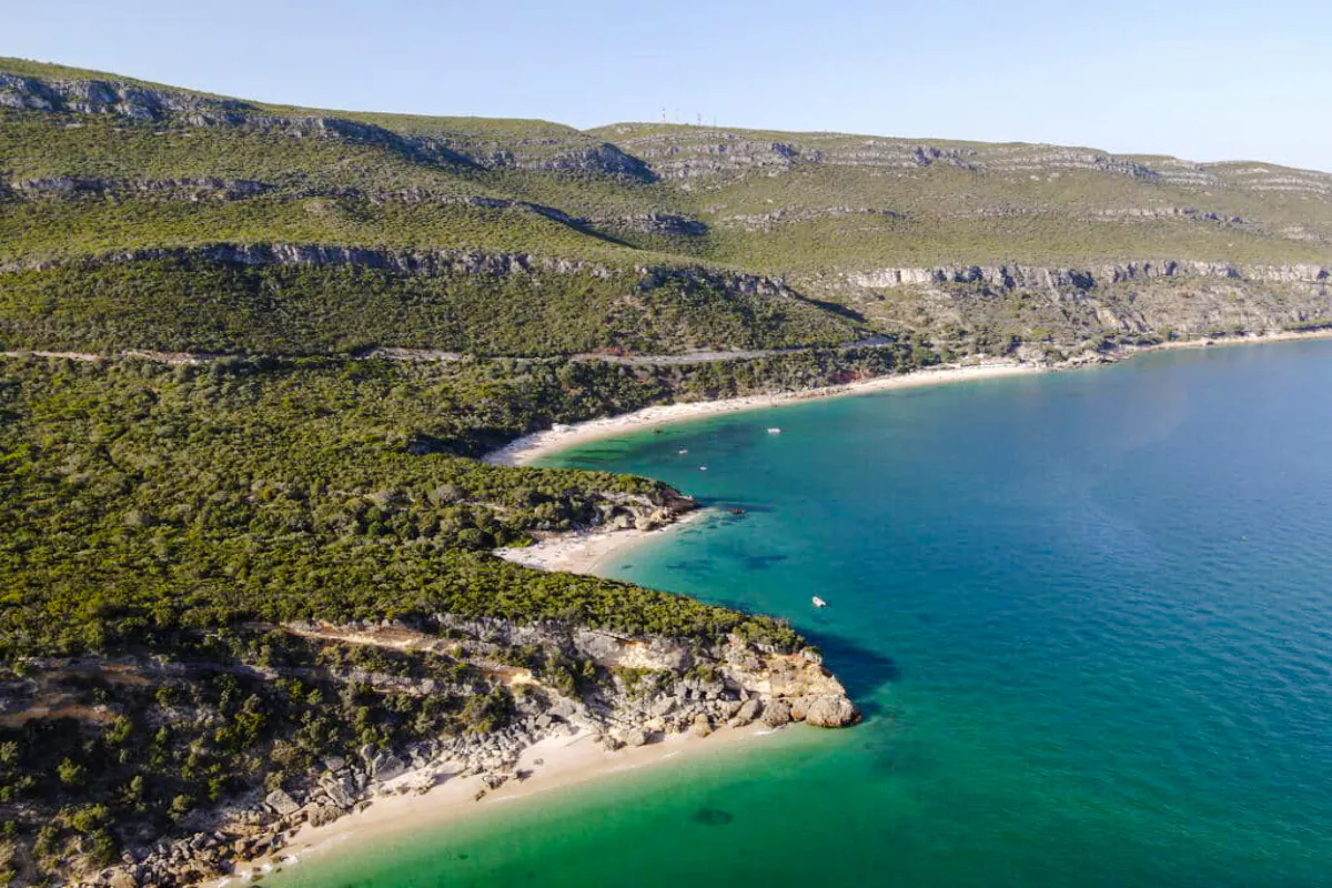 Aerial view of Arrábida coastline with green hills and blue sea, Lisbon.