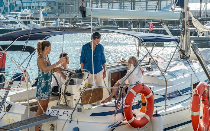 Group enjoying a sailing trip with a local captain on a sunny day.