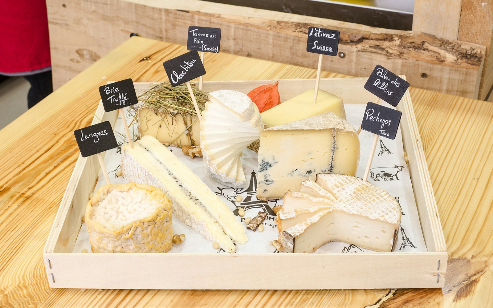 Cheese selection at Cheese Museum Paris, featuring Brie Truffé and Bleu des Causses.