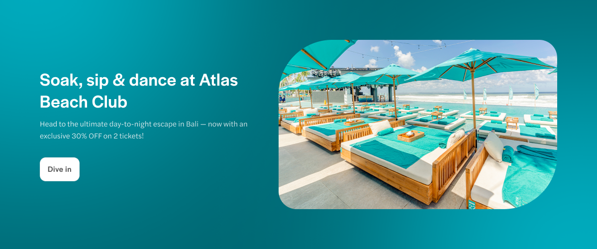 Sun loungers and umbrellas at Atlas Beach Club, Bali, overlooking the ocean.