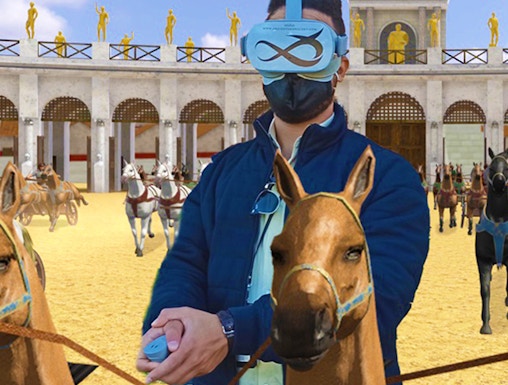 Man using VR headset for chariot racing experience at Circus Maximus, Rome.