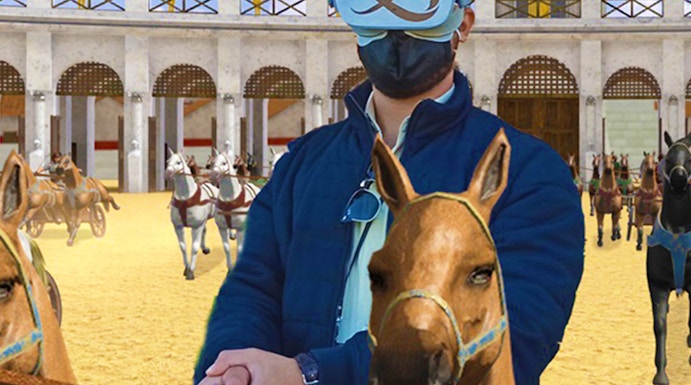 Man using VR headset for chariot racing experience at Circus Maximus, Rome.