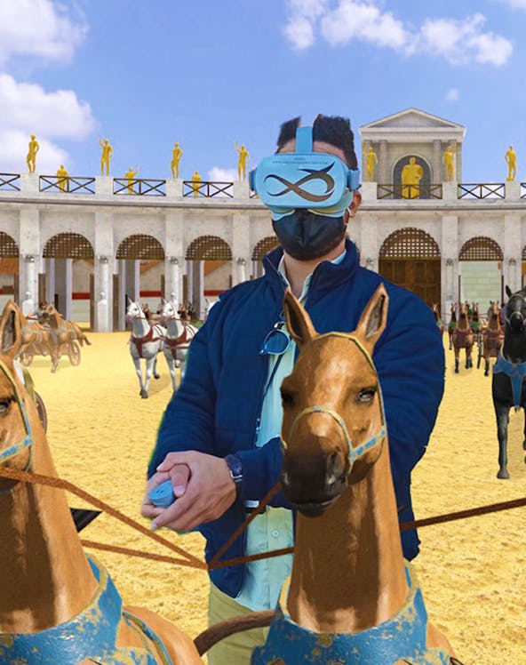 Man using VR headset for chariot racing experience at Circus Maximus, Rome.