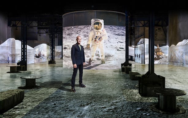 Moonwalkers Exhibition at Atelier des Lumières featuring astronaut projection.