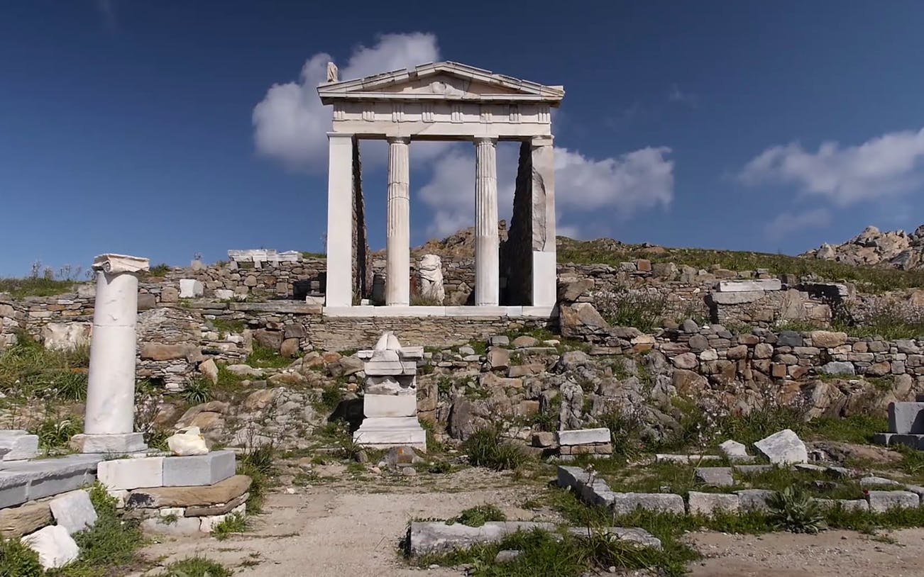 Ancient ruins of Delos Archaeological Site with stone columns and temple remains.