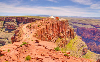 Visitors walking along the rocky path at Guano Point, Grand Canyon West Rim.