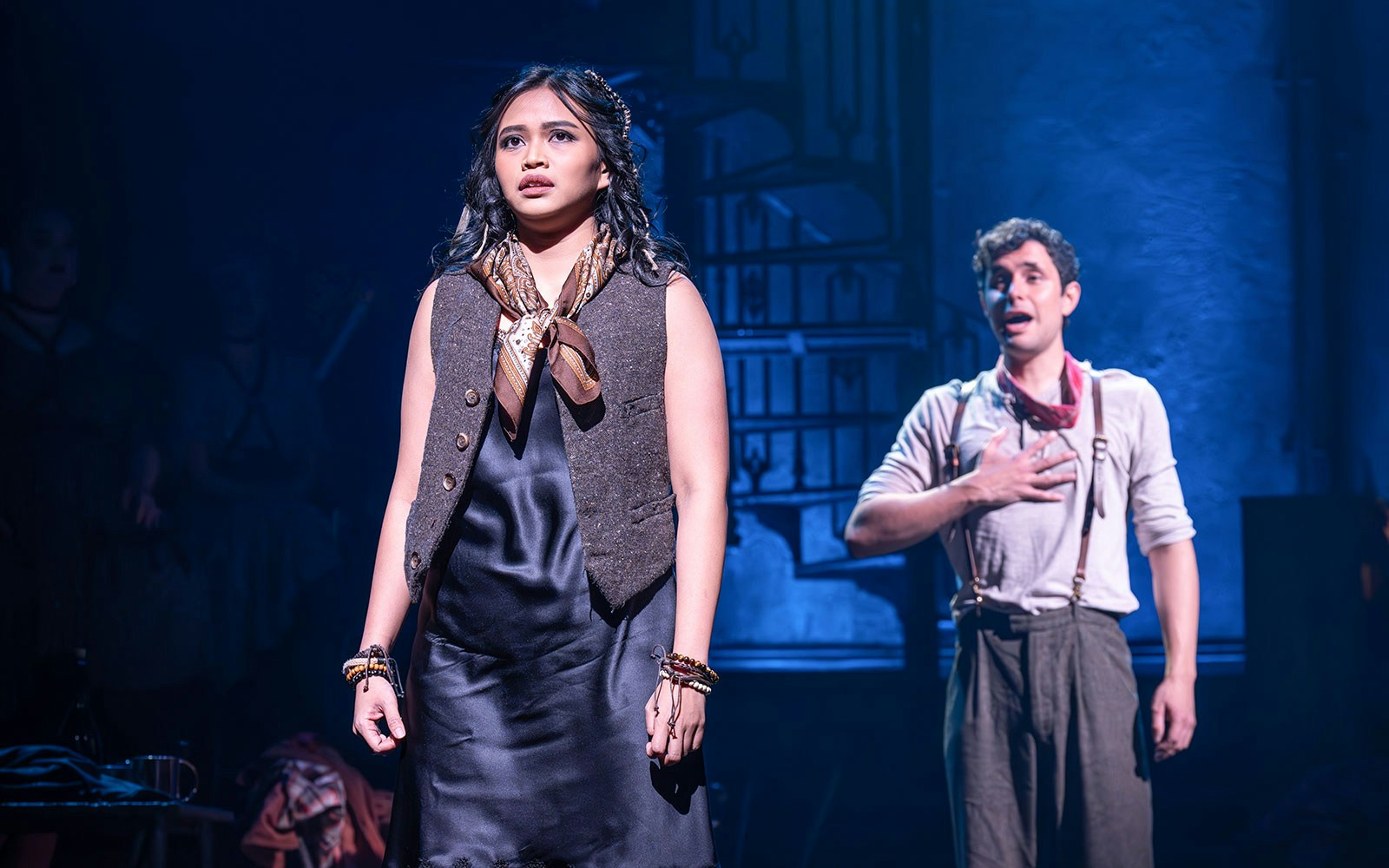 Actors performing a dramatic scene in a ghost story theater production.