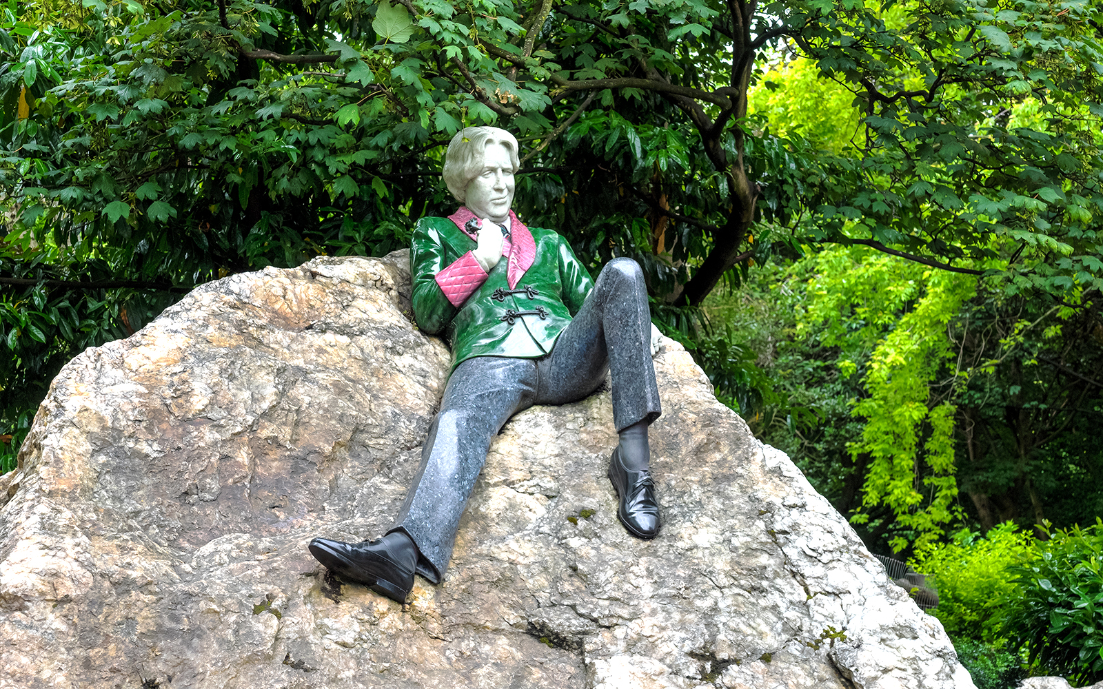 Merrion Square Park Dublin hop-on hop-off bus near historic Georgian buildings.