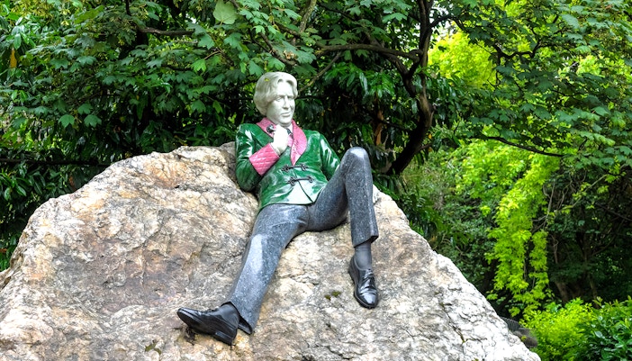 Merrion Square Park Dublin hop-on hop-off bus near historic Georgian buildings.