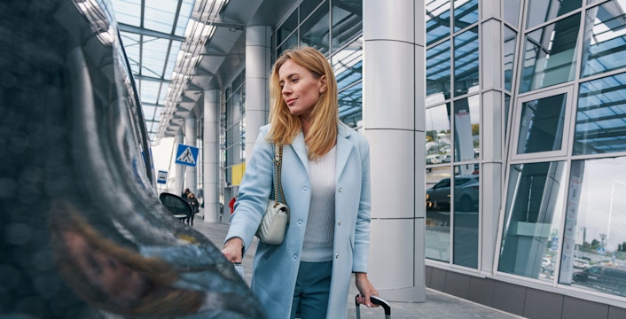 girl getting in the car at airport
