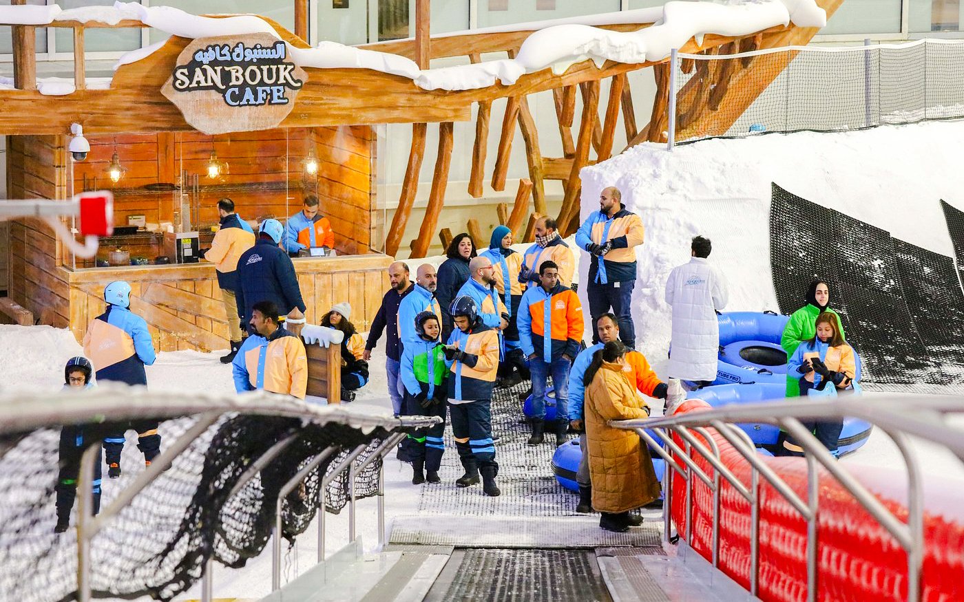 Visitors in winter gear at Snow Dunes Theme Park near Sanbouk Cafe.