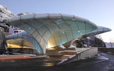 Nordkettenbahn station with modern architecture in Innsbruck, Austria, against a mountain backdrop.