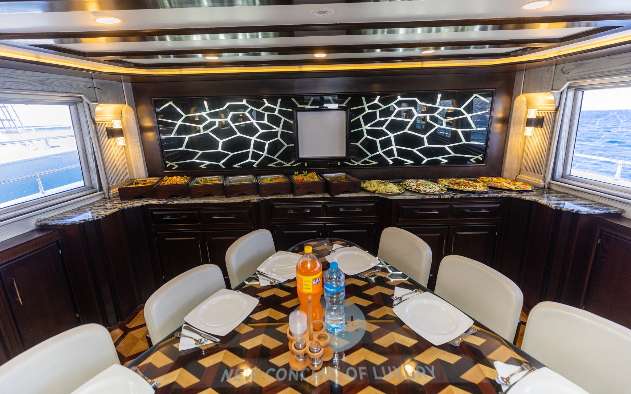 Interior dining area of a yacht with buffet spread, Orange Bay Island, Hurghada.