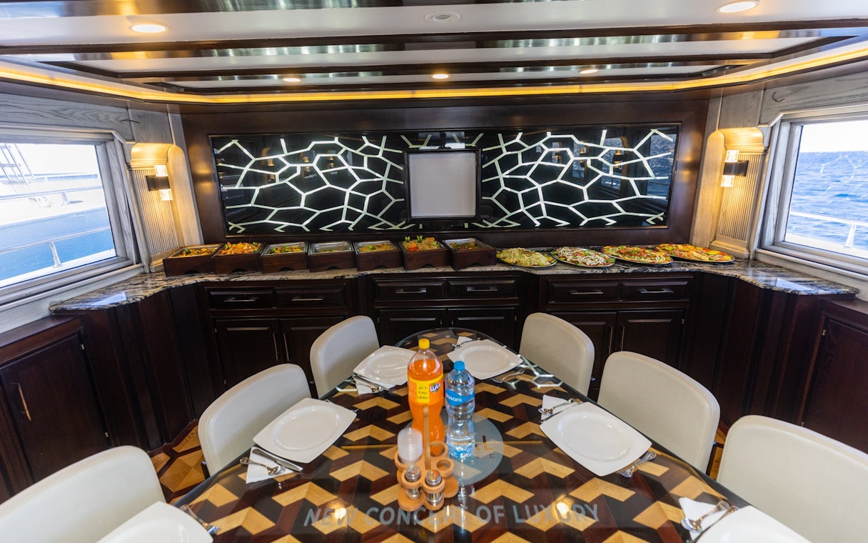 Interior dining area of a yacht with buffet spread, Orange Bay Island, Hurghada.