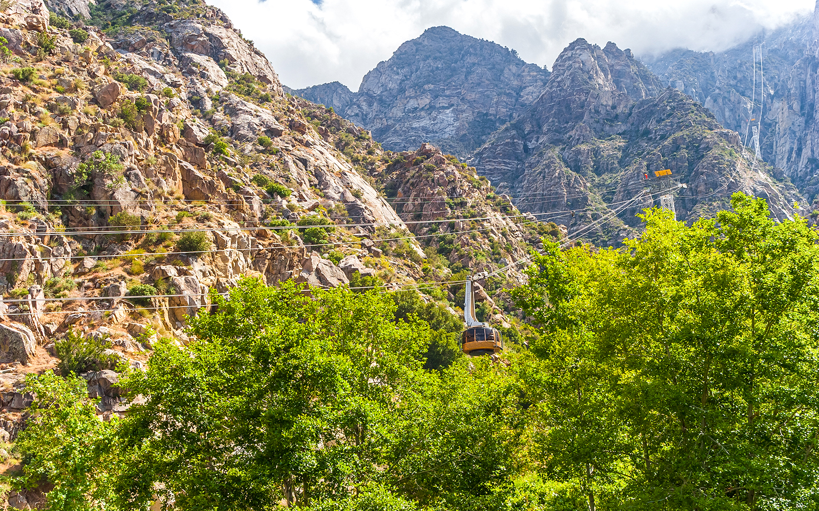 Tramway ascending rocky mountains at Palm Springs Aerial Tramway.
