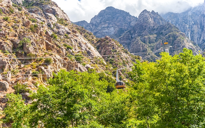 Tramway ascending rocky mountains at Palm Springs Aerial Tramway.