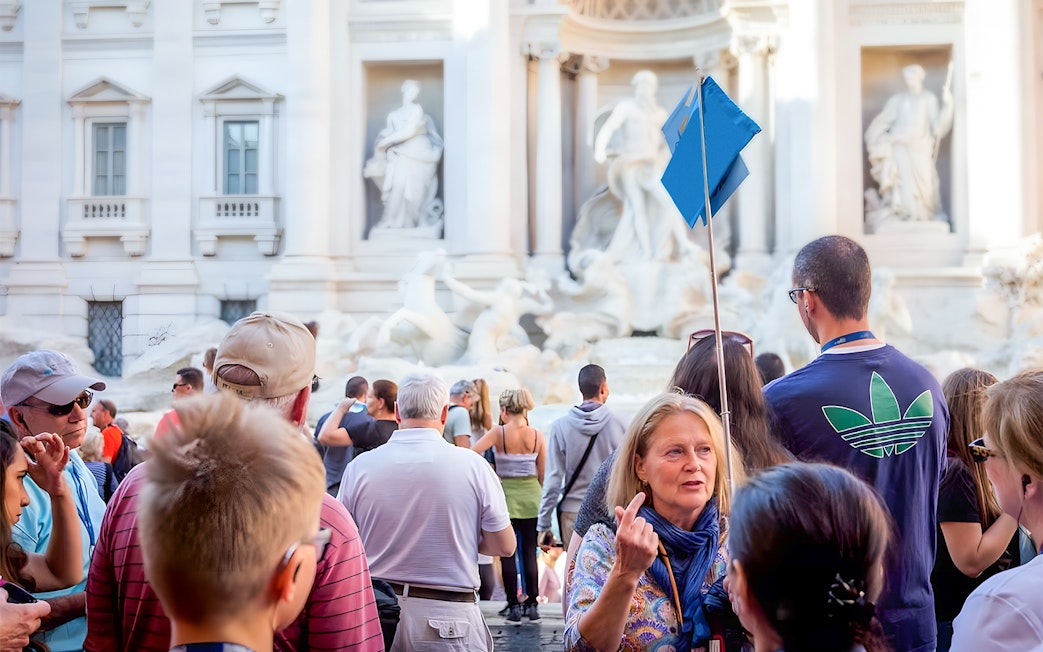Tour group at Trevi Fountain during guided walking tour in Rome.
