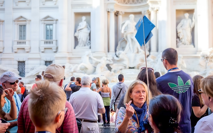 Tour group at Trevi Fountain during guided walking tour in Rome.