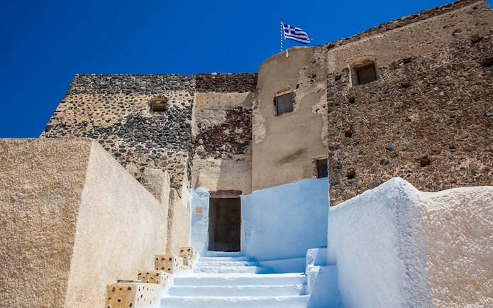 Stone walls and steps leading to the Ruins of the Castle of Akrotiri, Greece.