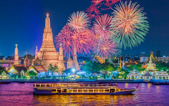 River cruise on Chao Phraya with Wat Arun and fireworks in Bangkok.