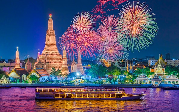 River cruise on Chao Phraya with Wat Arun and fireworks in Bangkok.