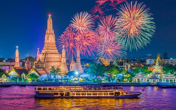 River cruise on Chao Phraya with Wat Arun and fireworks in Bangkok.