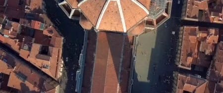 Gondola gliding through Venice canal with historic buildings in the background.
